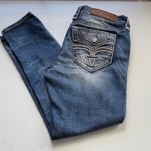 Women’s Rock Revival “Raven” skinny jeans.  Faux Button flap back pockets.